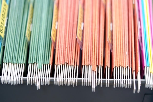 Close-up shot of a well-organized coupon binder with various sections labeled for different product categories such as 