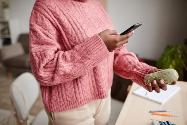 A person holding their smartphone, with a budgeting app open on the screen, showing categories and spending limits. The background is a cozy home environment.