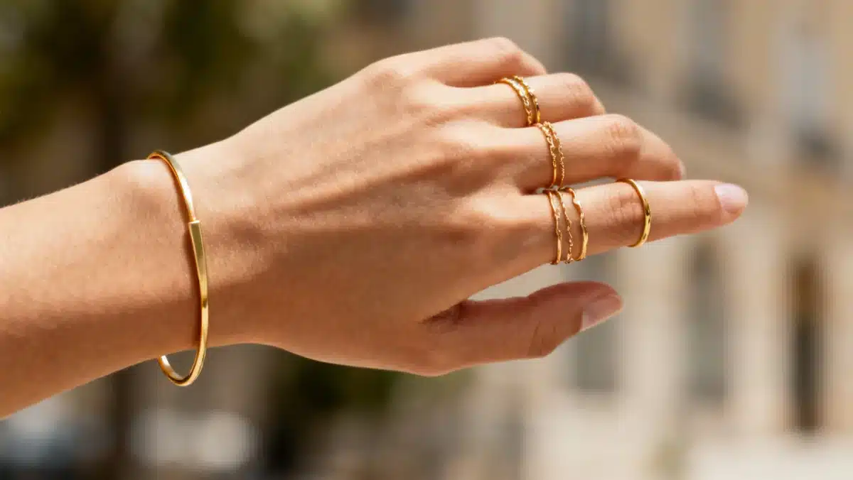 Layered delicate gold rings and minimalist bracelet for everyday wear